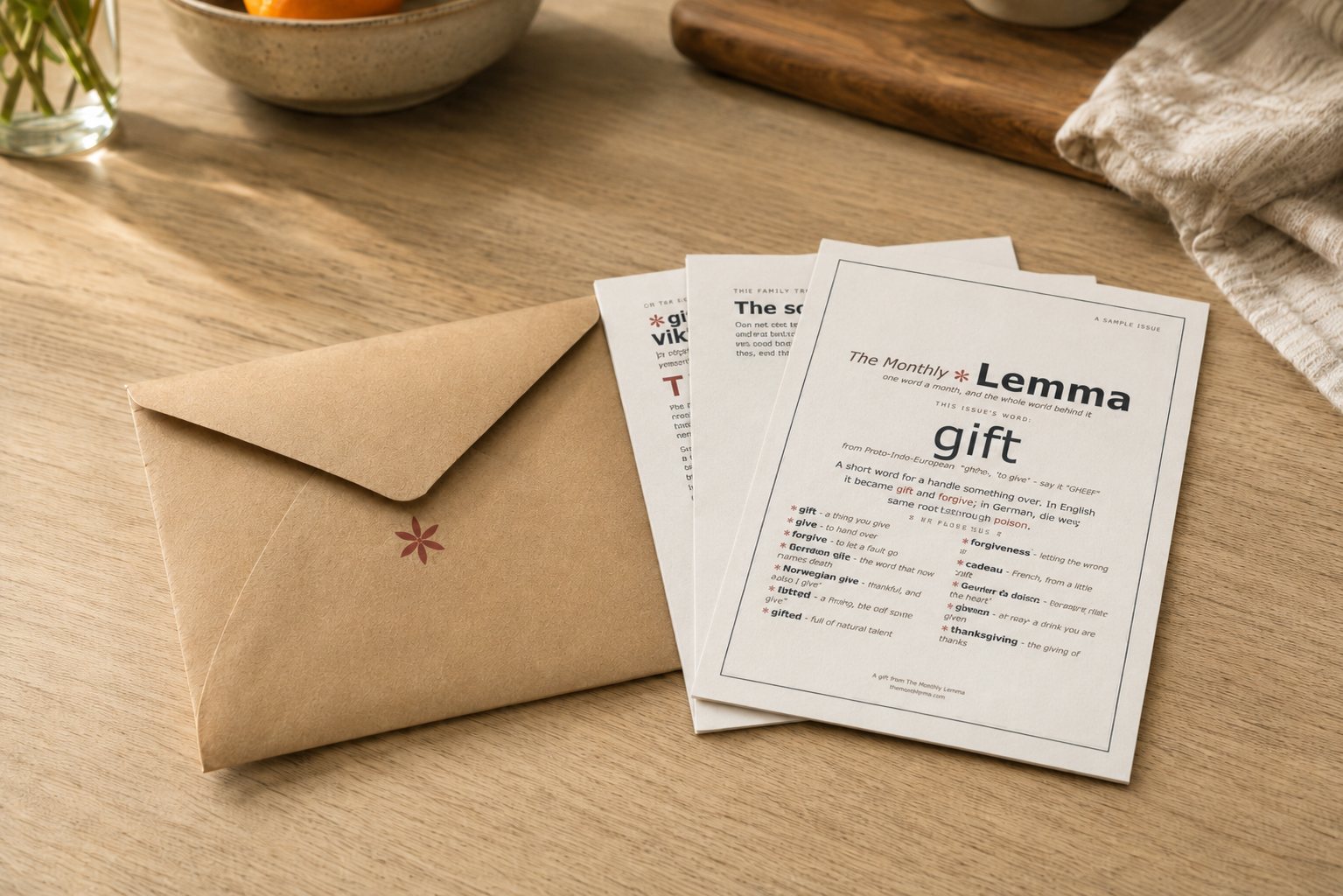 An issue of The Monthly Lemma with its pages fanned out beside the envelope it arrived in